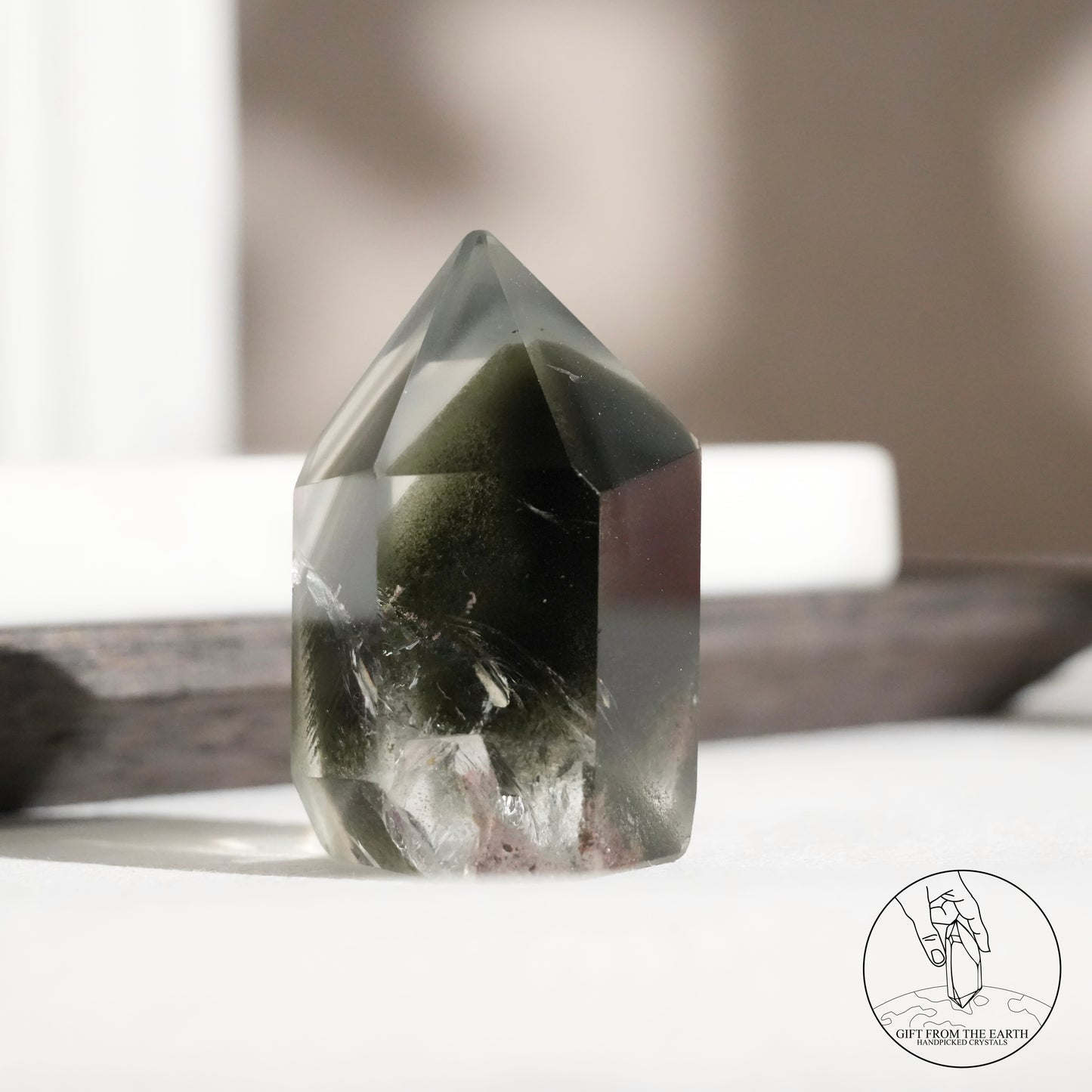 Half-polished multi-layered red-green phantom quartz point
