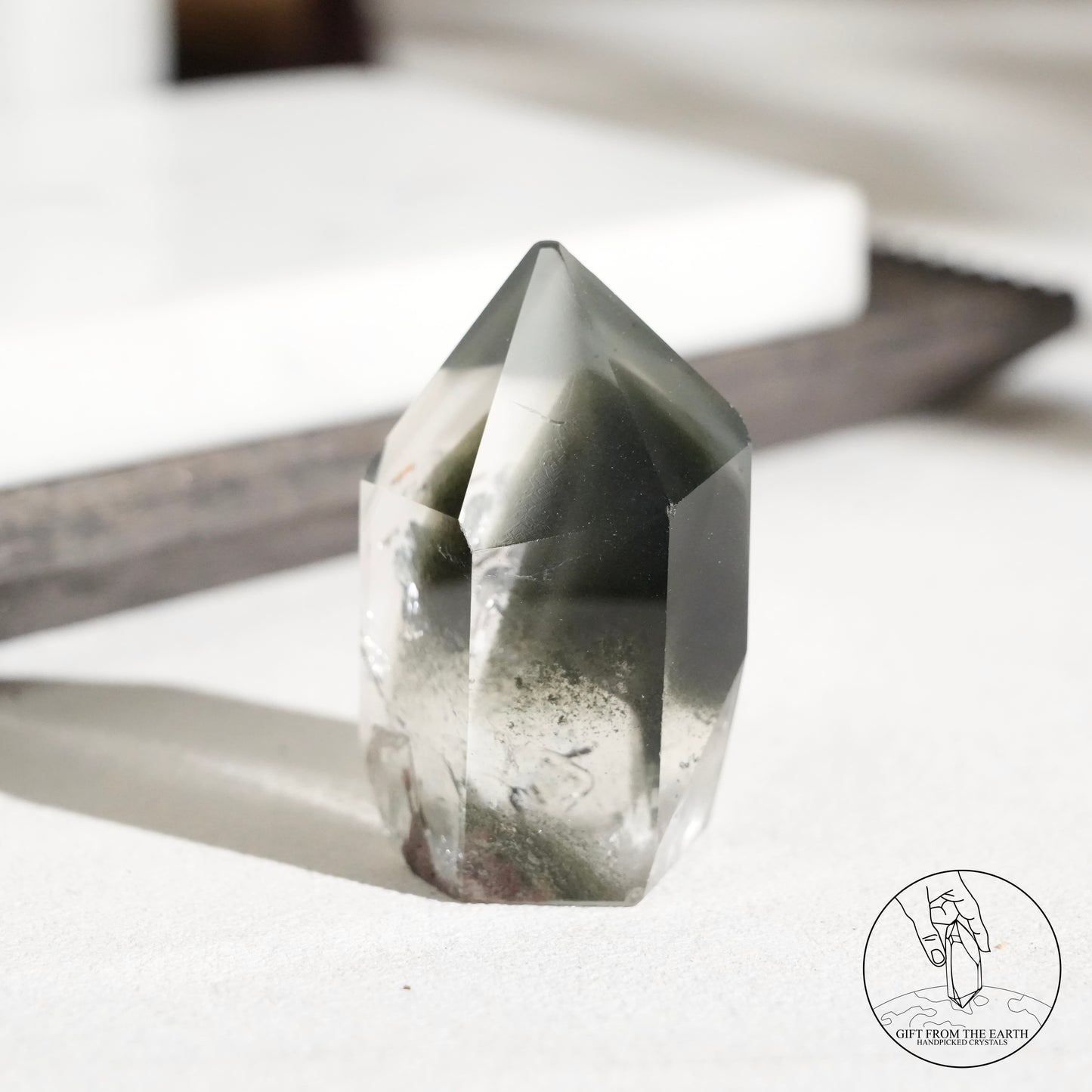 Half-polished multi-layered red-green phantom quartz point