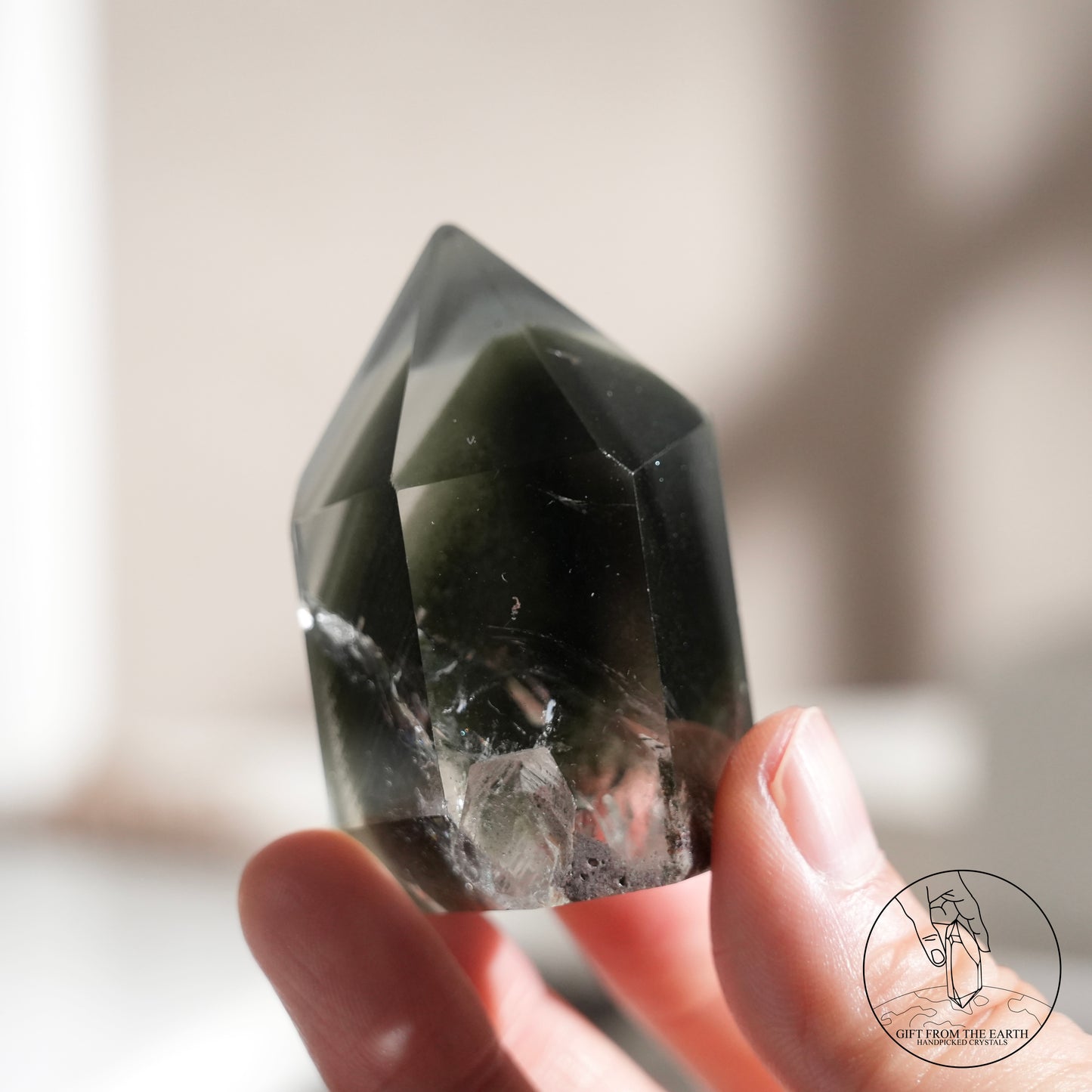 Half-polished multi-layered red-green phantom quartz point